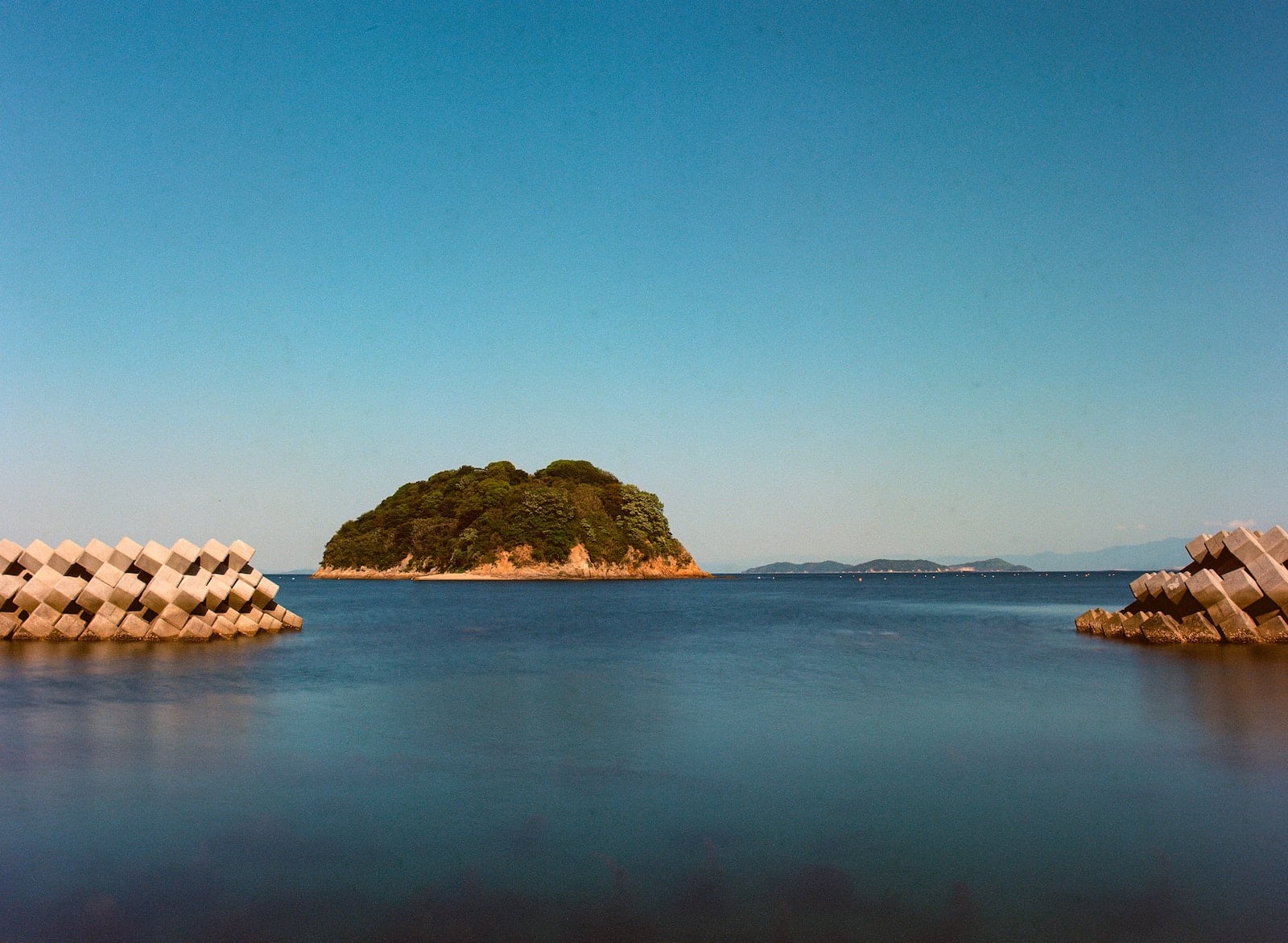 brown rock formation on body of water during daytime