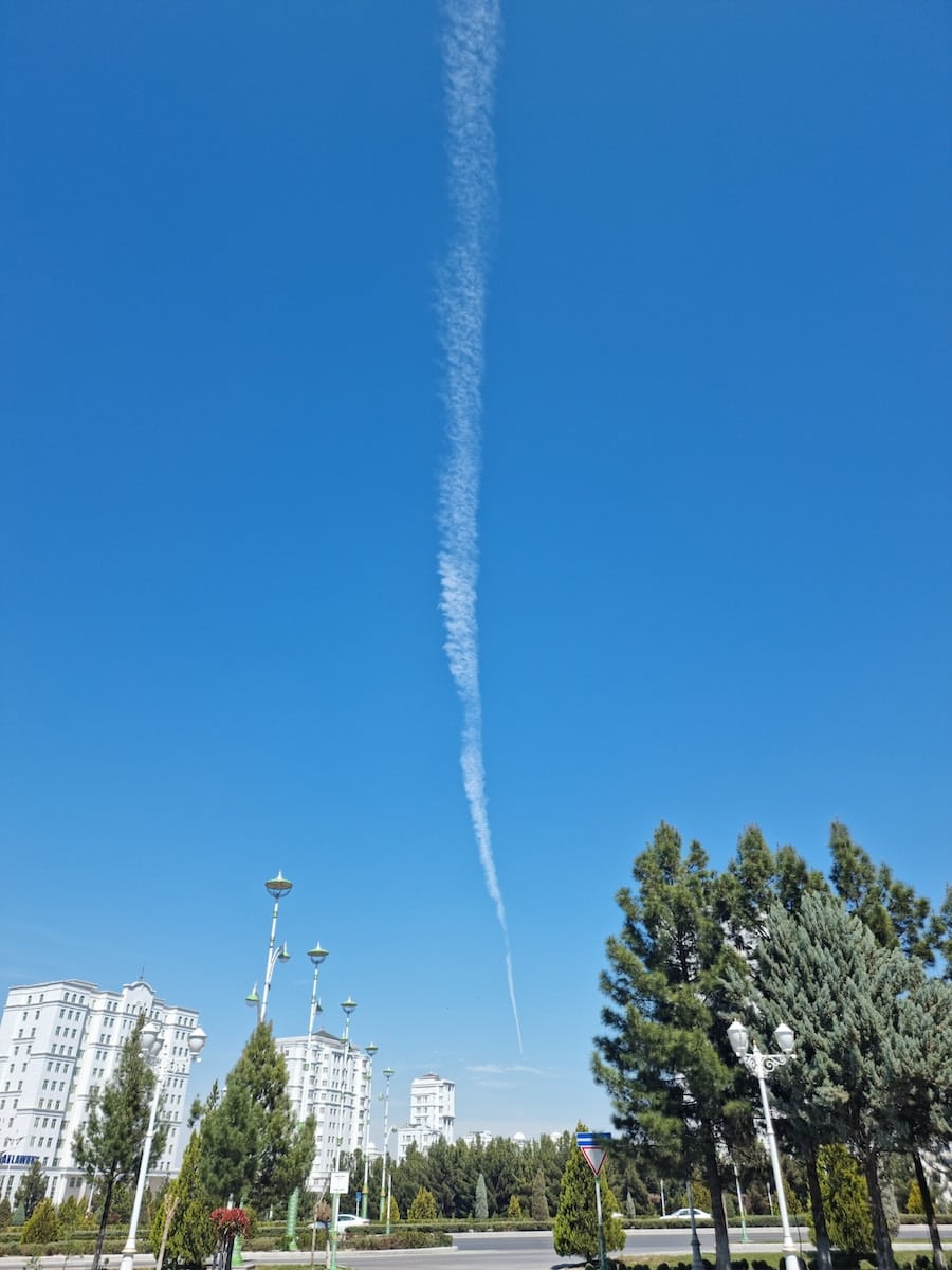 an airplane is flying in the blue sky